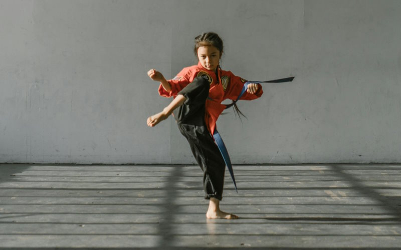 Girl doing karate indoors